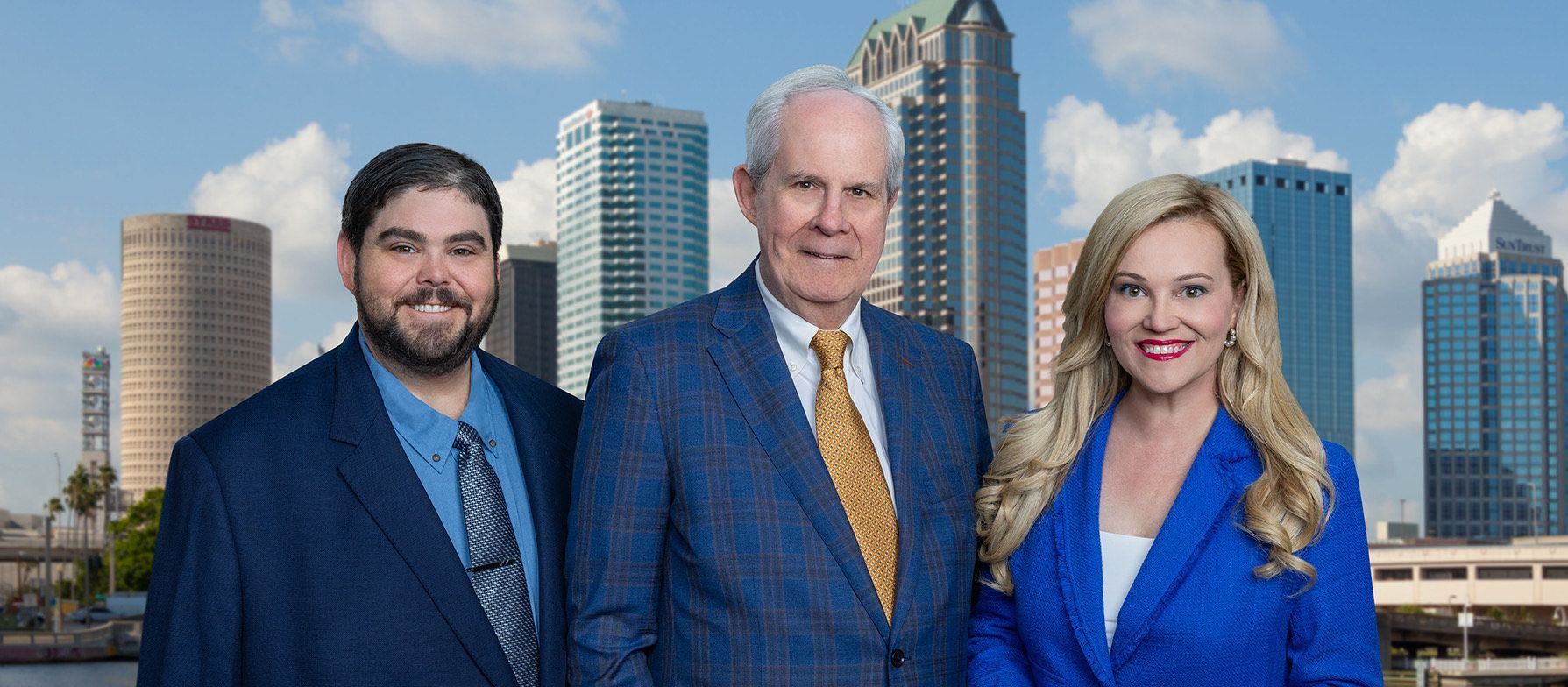 Three people in suits and ties are posing for a picture in front of a city skyline. - Tampa, Fl - J.h. Williams Oil Company Incorporated