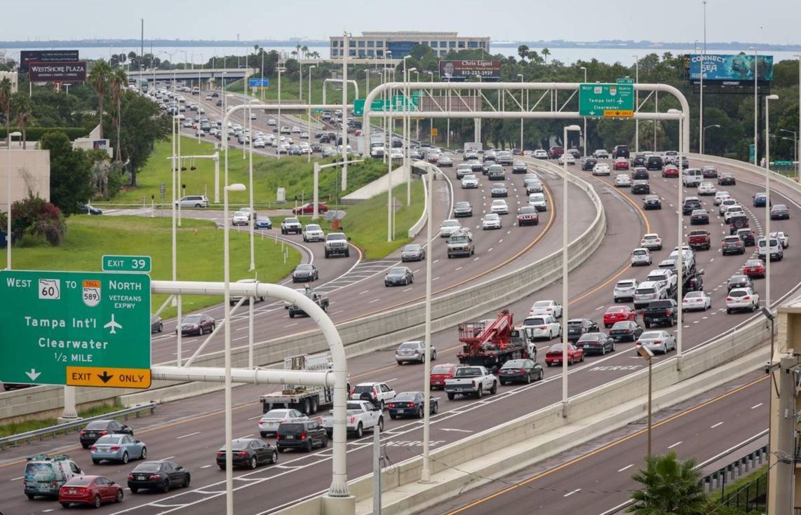 A highway with a lot of cars driving down it