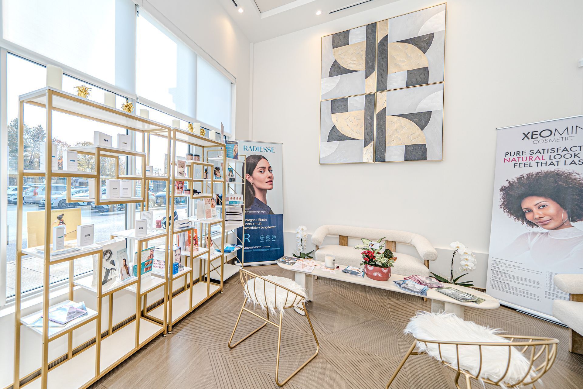 A room with a couch , chairs , shelves and a painting on the wall.