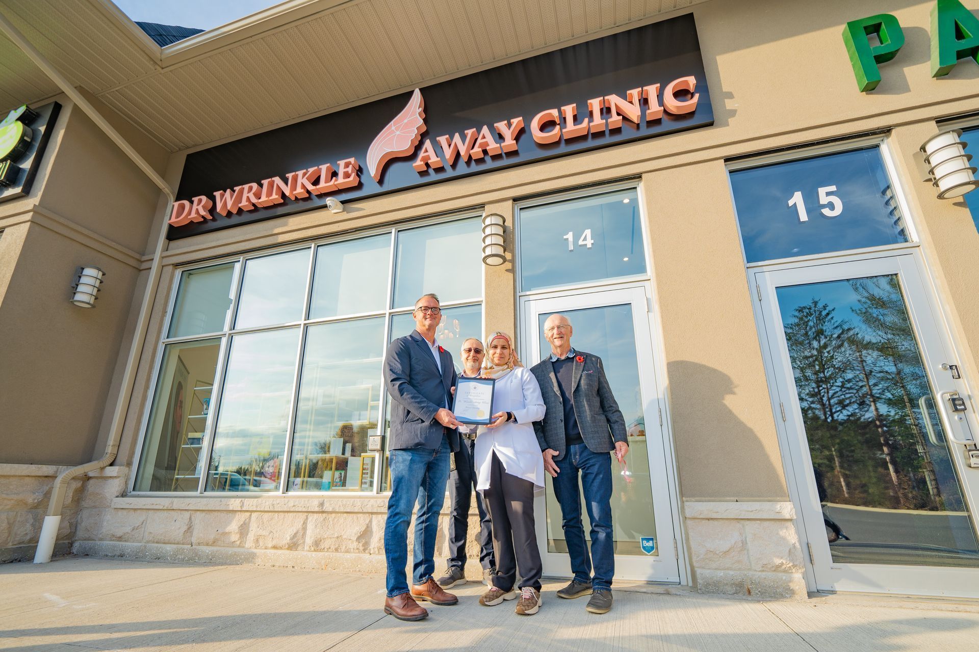 A group of people standing in front of Dr Wrinkle Away Clinic.