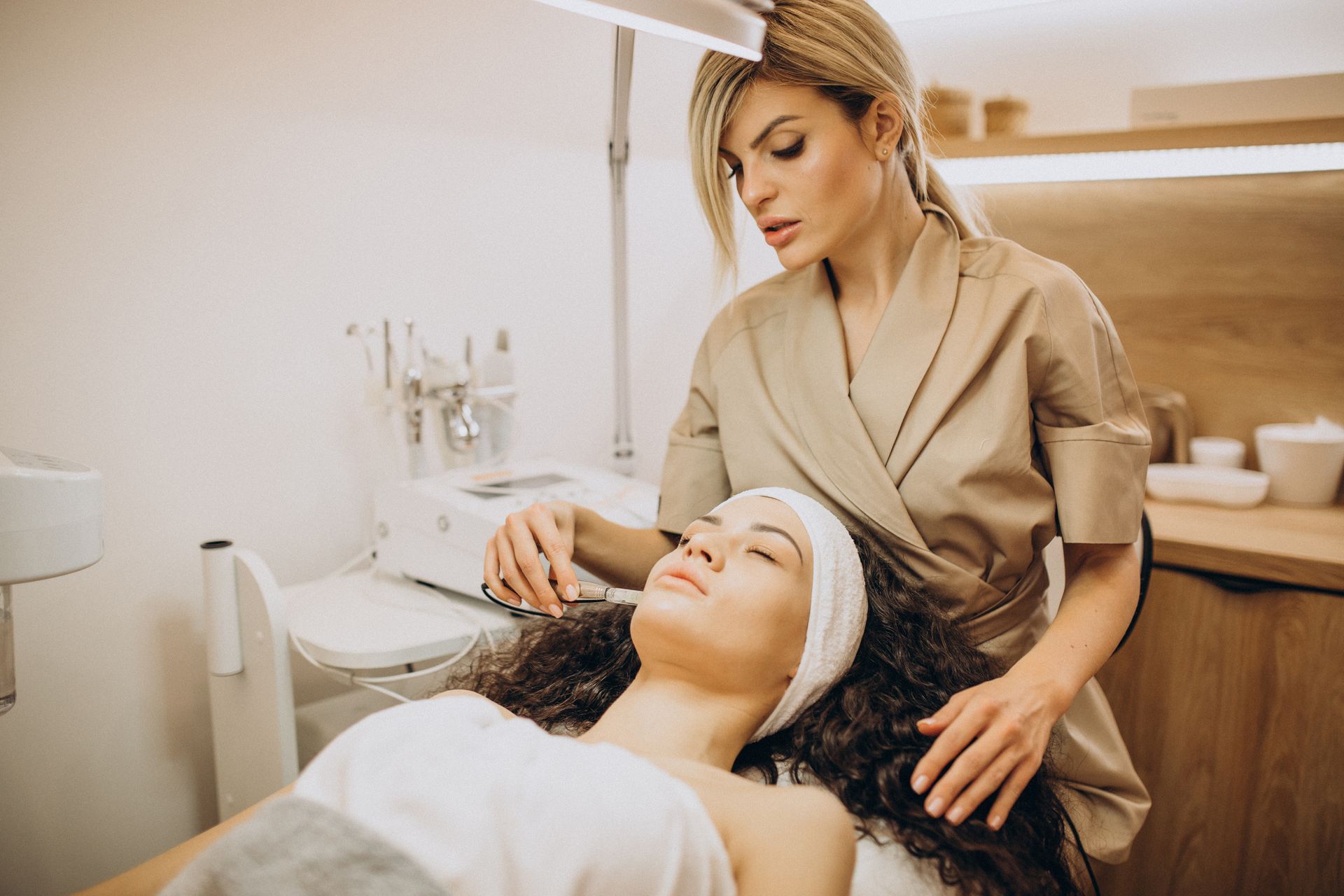 A woman is getting a facial treatment in a beauty salon.