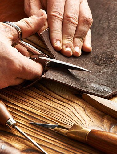 Man Cutting the Leather — Beaverton, OR — Vanek's Shoe Repair