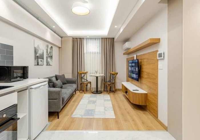 A living room with a couch , table and television.