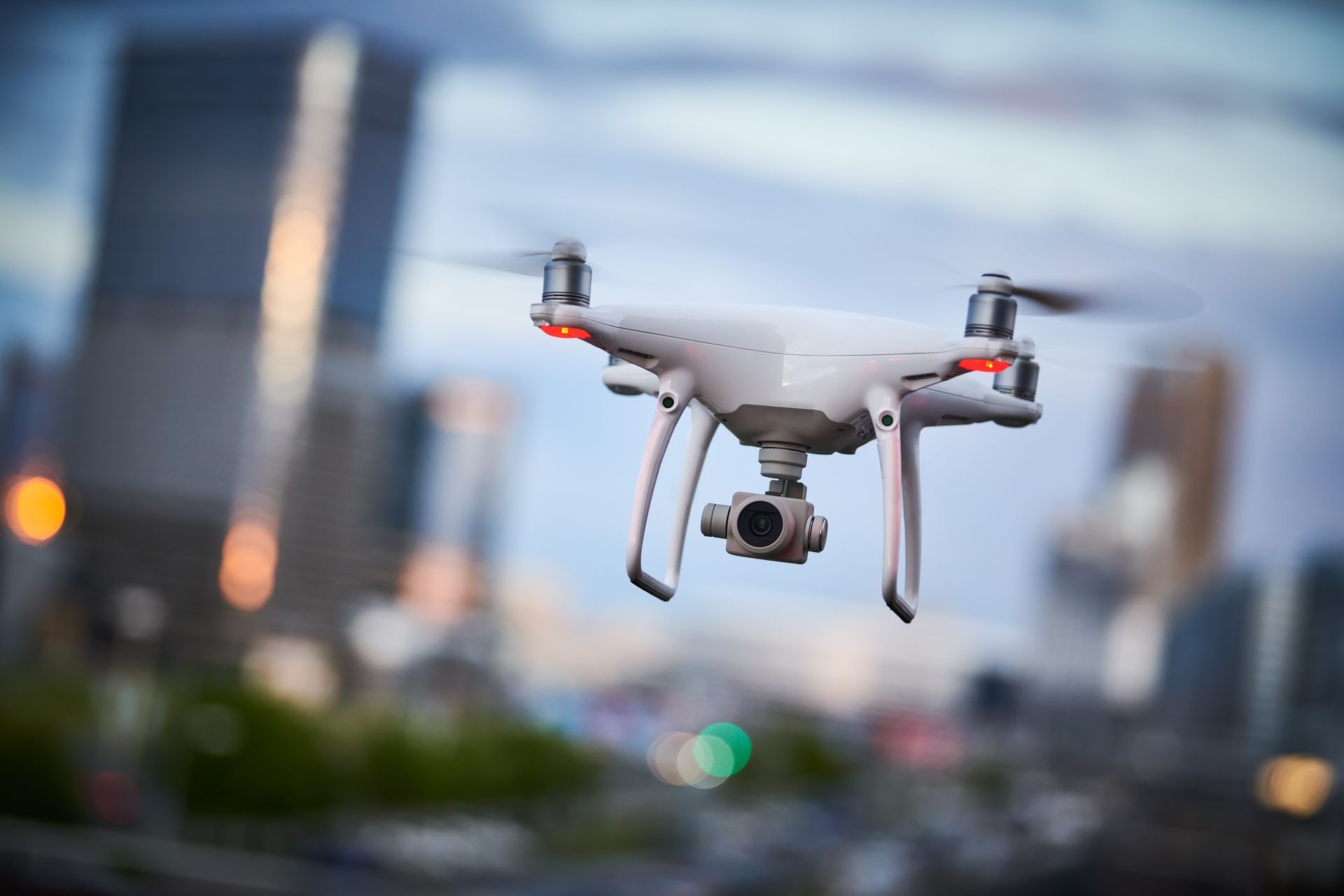A drone is flying over a city at night.