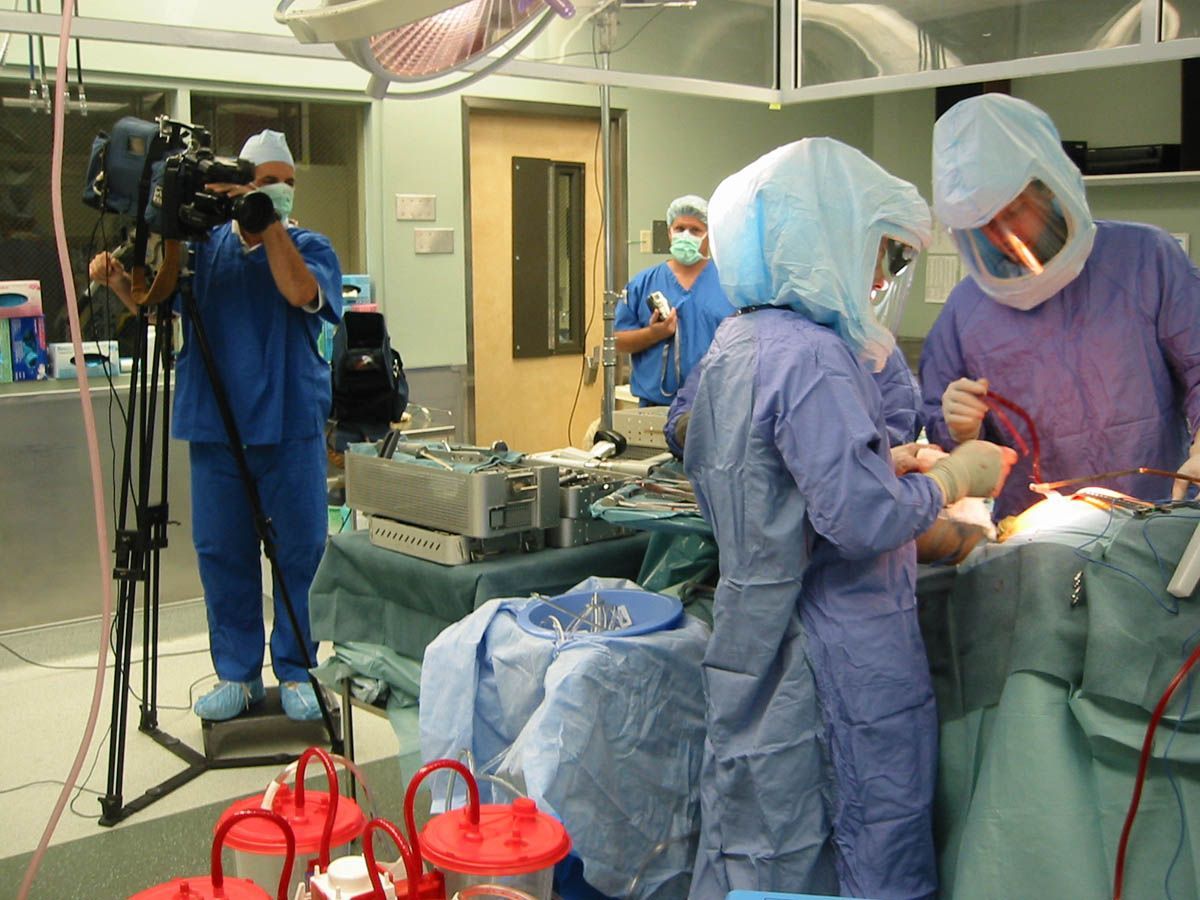 A group of surgeons are performing surgery in an operating room