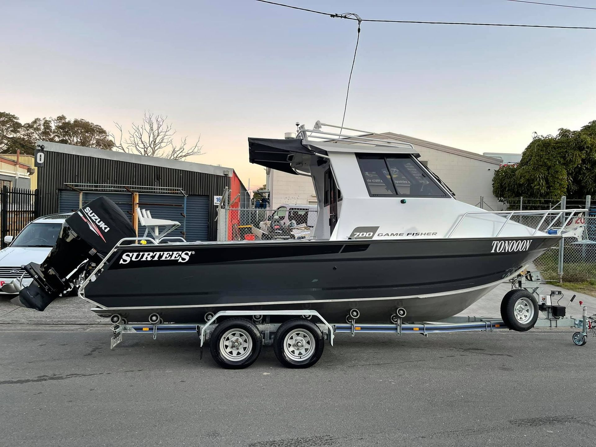 A Boat Is Parked on A Trailer in A Parking Lot — Don's Marine Repairs in Ettalong, NSW