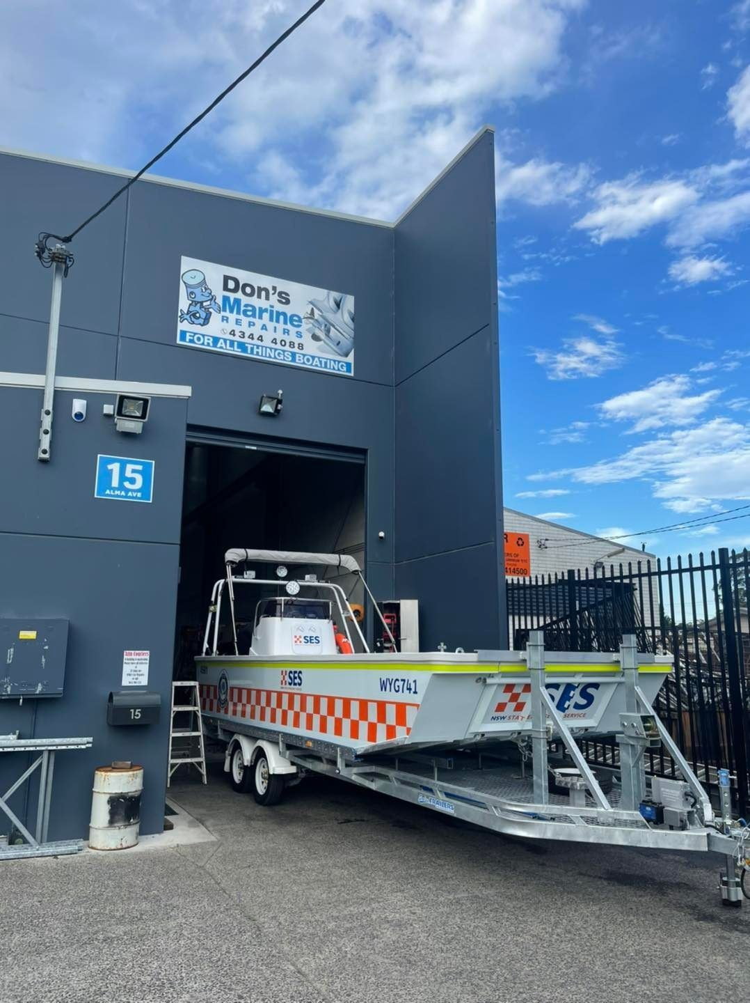 A Boat on A Trailer Is Parked in Front of A Building — Don's Marine Repairs in Woy Woy, NSW