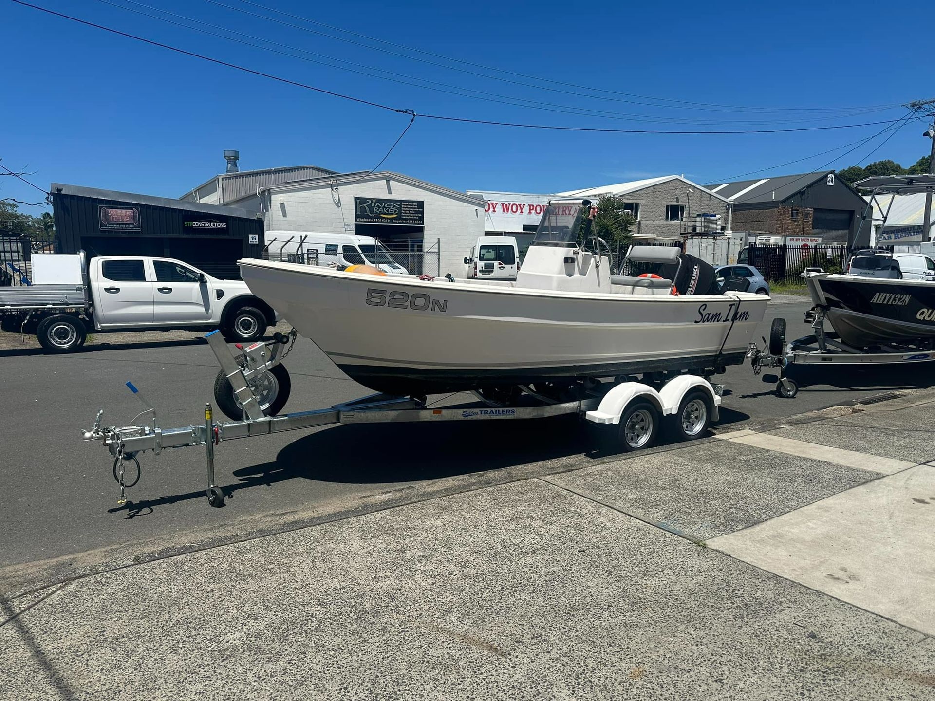 A Boat on A Trailer Is Parked on The Side of The Road — Don's Marine Repairs in Woy Woy, NSW