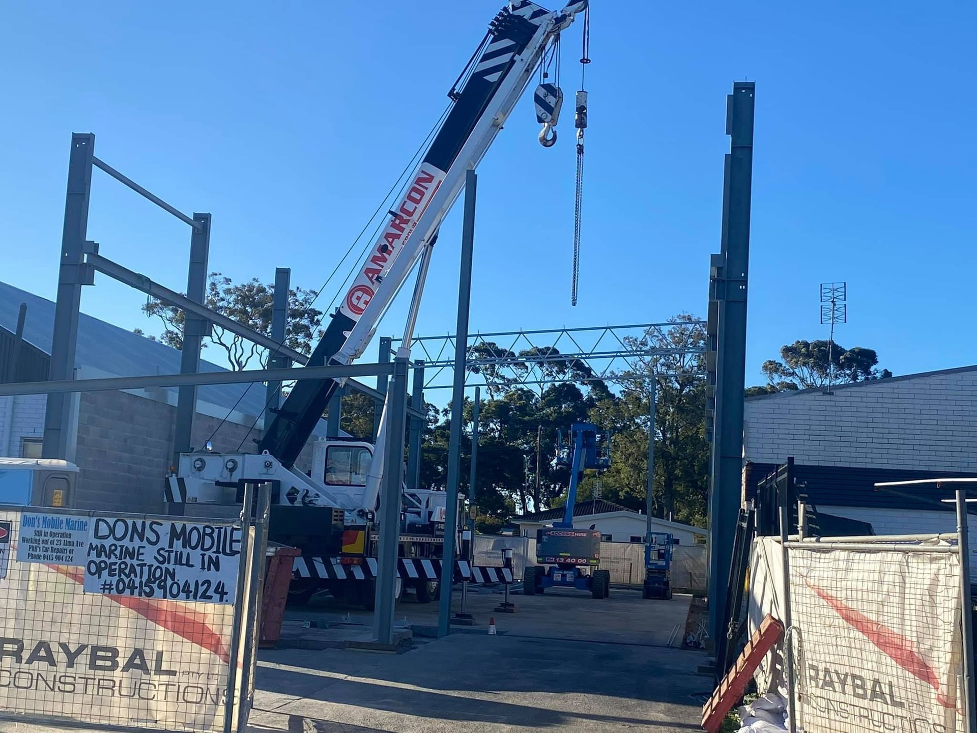 A Construction Site with A Crane and A Sign — Don's Marine Repairs in Ettalong, NSW