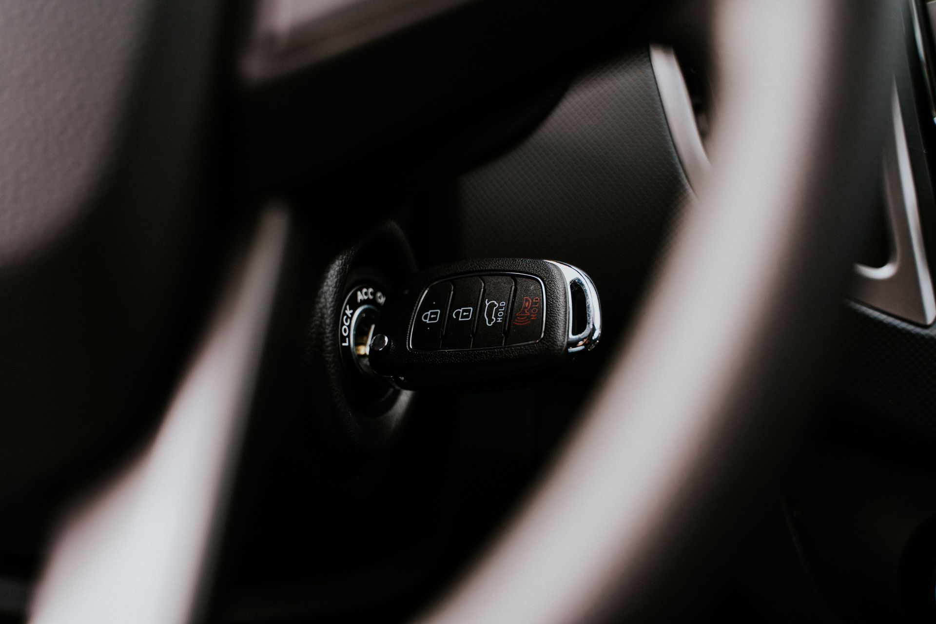 Close-up of a car steering wheel and dashboard controls in a dark interior