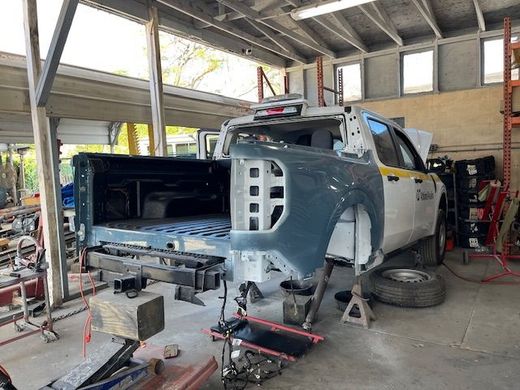 A truck is being worked on in a garage.