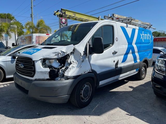 A damaged xfinity van is parked in a parking lot