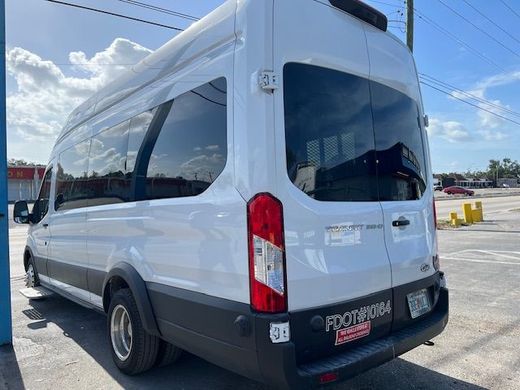 A white van is parked in a parking lot.
