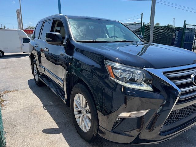 A black lexus gx is parked in a parking lot.