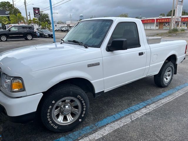 A white pickup truck is parked in a parking lot.