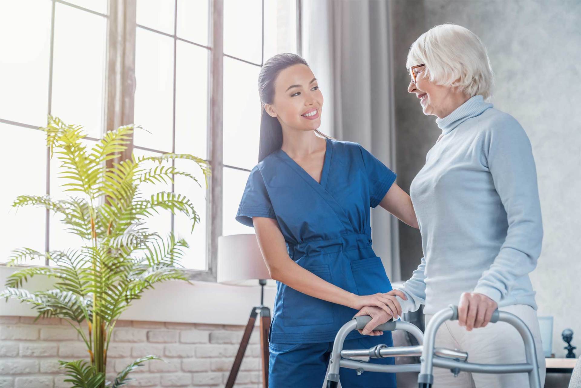 Female Helping Senior Woman to Walk with Walker — St. Paul, Minnesota — Care Plus HHA Female Helping Senior Woman to Walk with Walker — St. Paul, Minnesota — Care Plus HHA