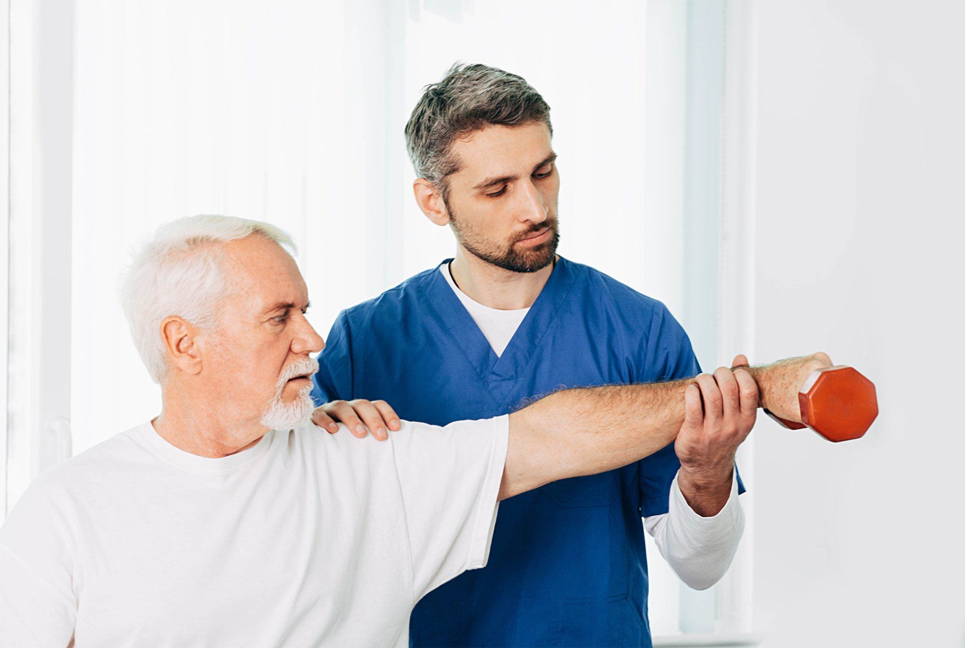 Physiotherapist Helping His Patient to Lift a Dumbbell — St. Paul, Minnesota — Care Plus HHA Physiotherapist Helping His Patient to Lift a Dumbbell — St. Paul, Minnesota — Care Plus HHA