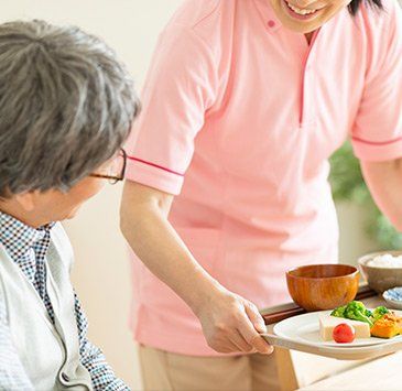 Care Worker Delivering Meals — St. Paul, Minnesota — Care Plus HHA Care Worker Delivering Meals — St. Paul, Minnesota — Care Plus HHA