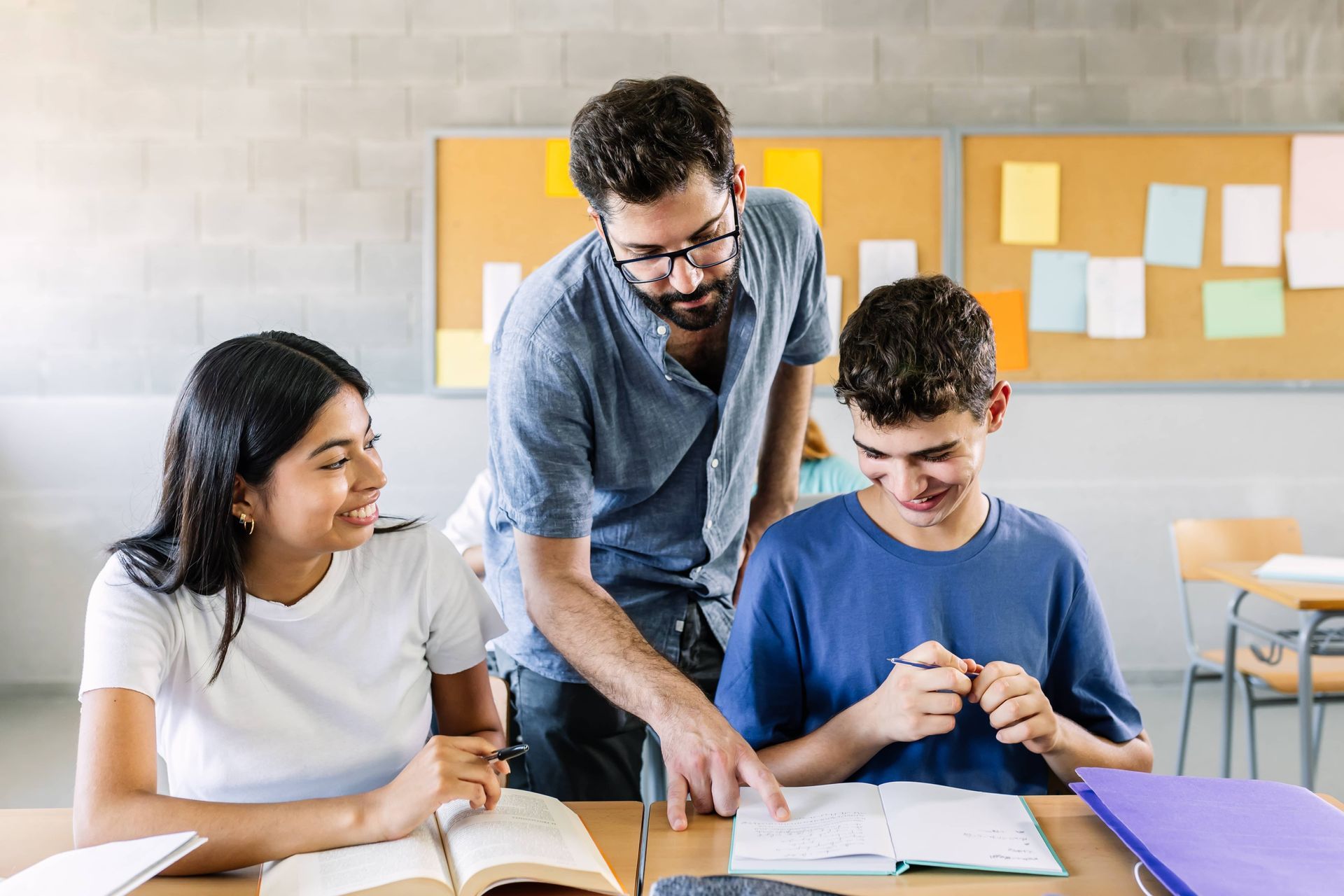 Teacher helping students in a classroom.