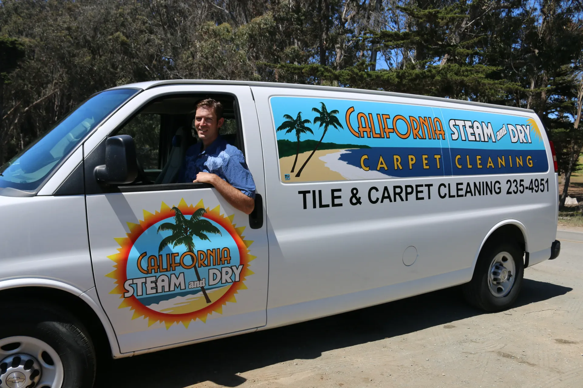 A man is standing in front of a california steam dry van