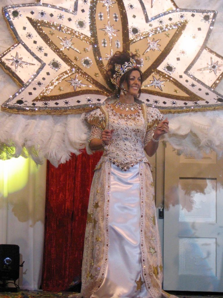 A woman in a white dress with feathers on her wings