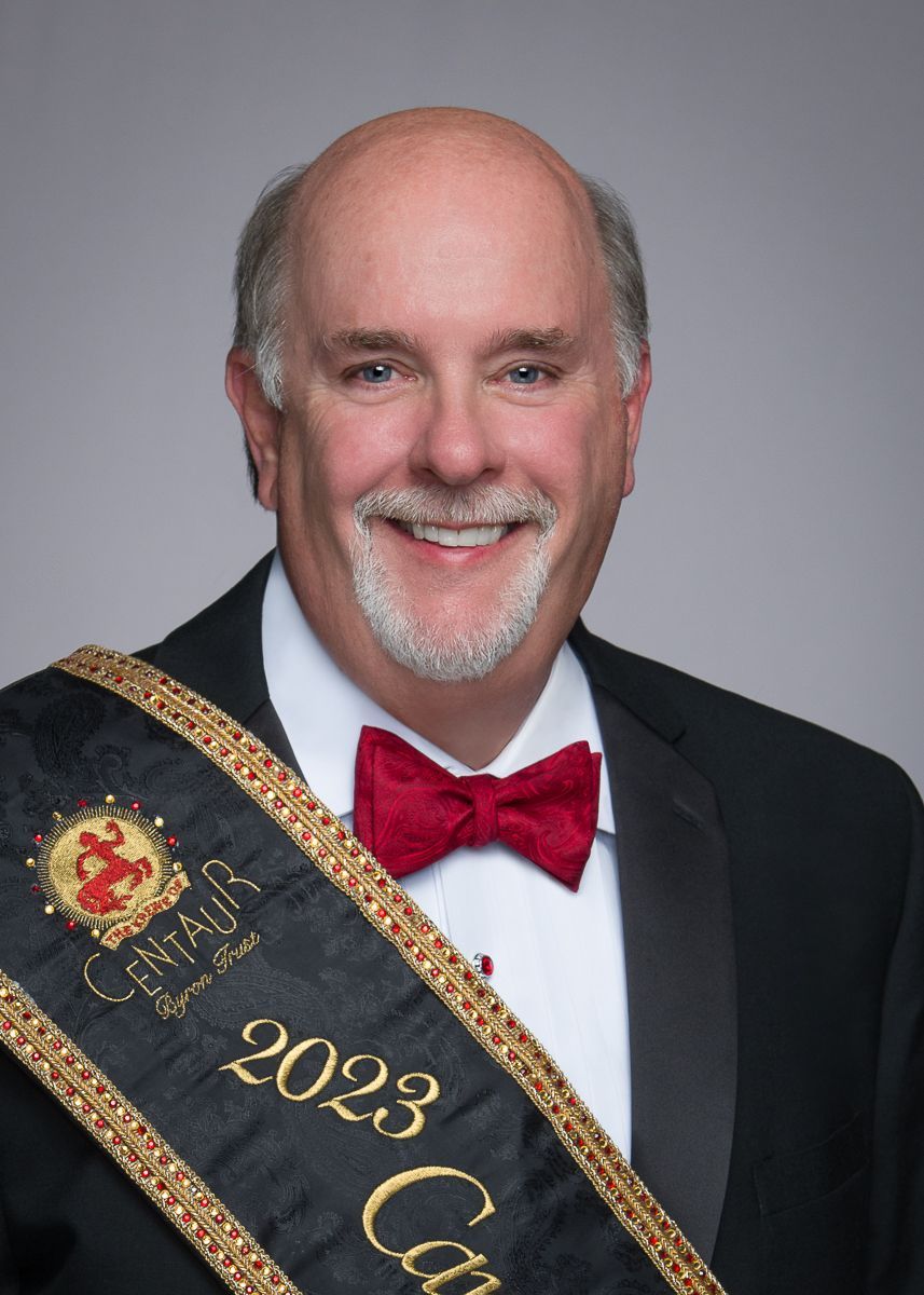 A man wearing a sash that says 2023 on it