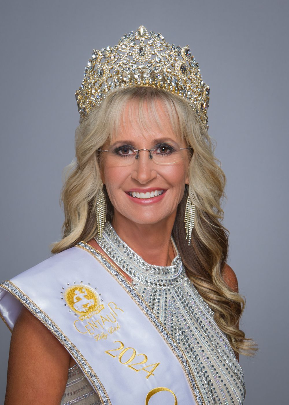 A woman is wearing a crown and a sash that says ' miss america ' on it.