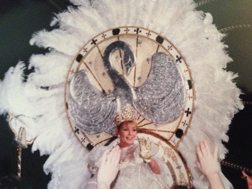 A woman in a white dress with a swan on it