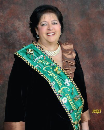 A woman wearing a sash that says 2012 captain centurion