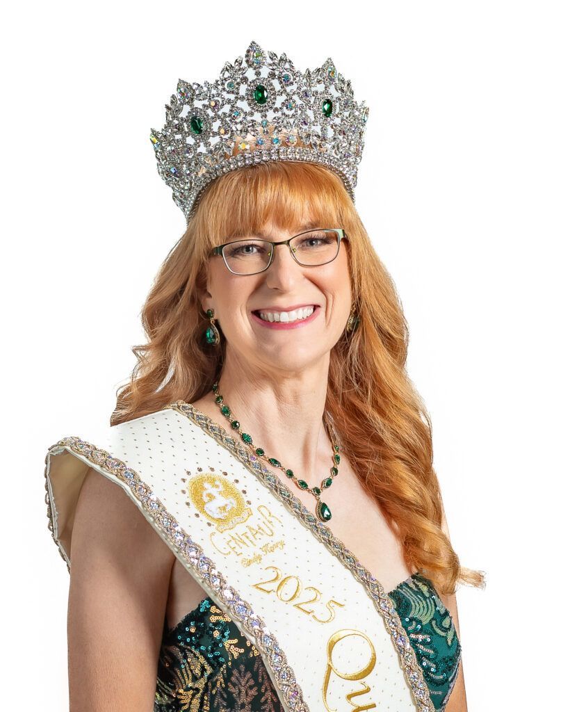 A woman wearing a crown and a sash is smiling.