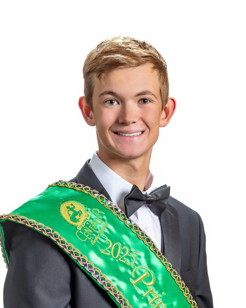 A young man in a suit and bow tie is wearing a green sash with the year 2022 on it