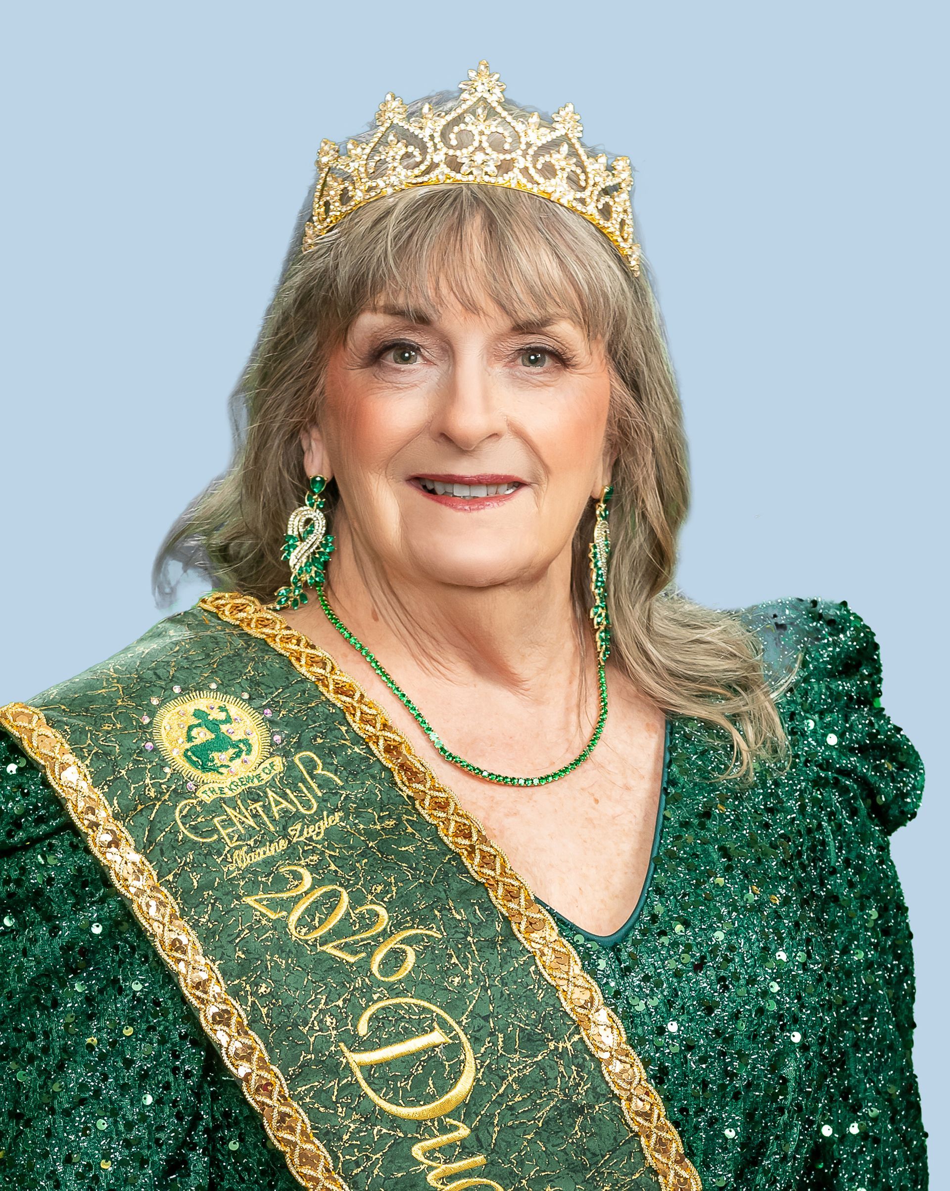 A woman wearing a tiara and a sash that says duchess on it