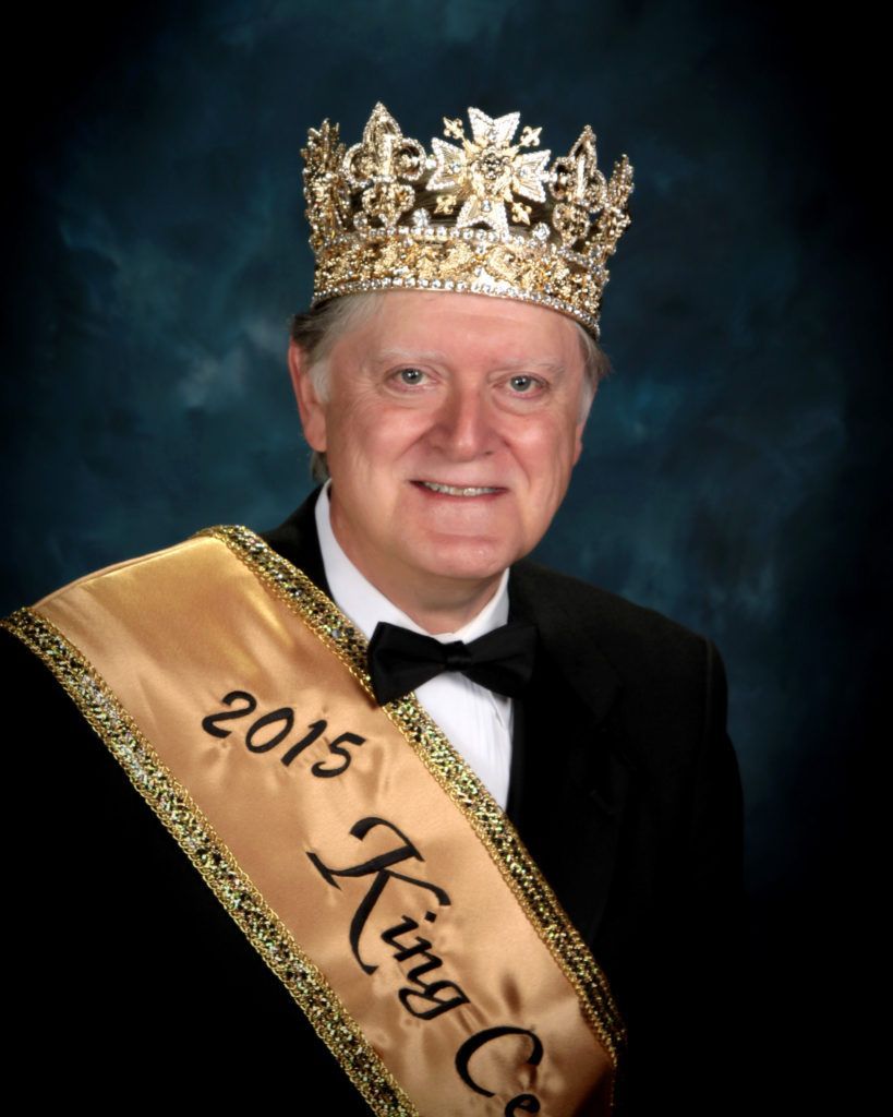 A man wearing a crown and a 2015 king sash
