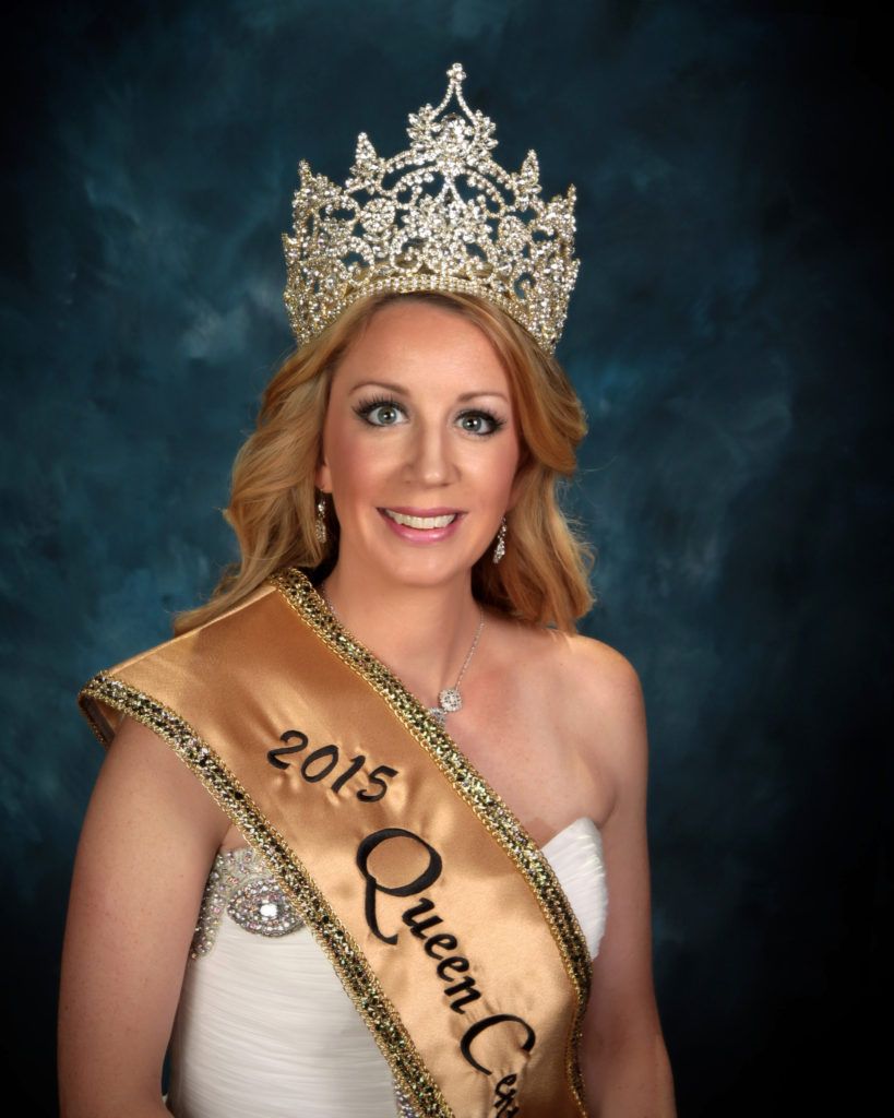 A woman wearing a 2015 queen crown and sash