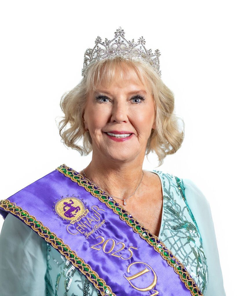 A woman is wearing a tiara and a purple sash.