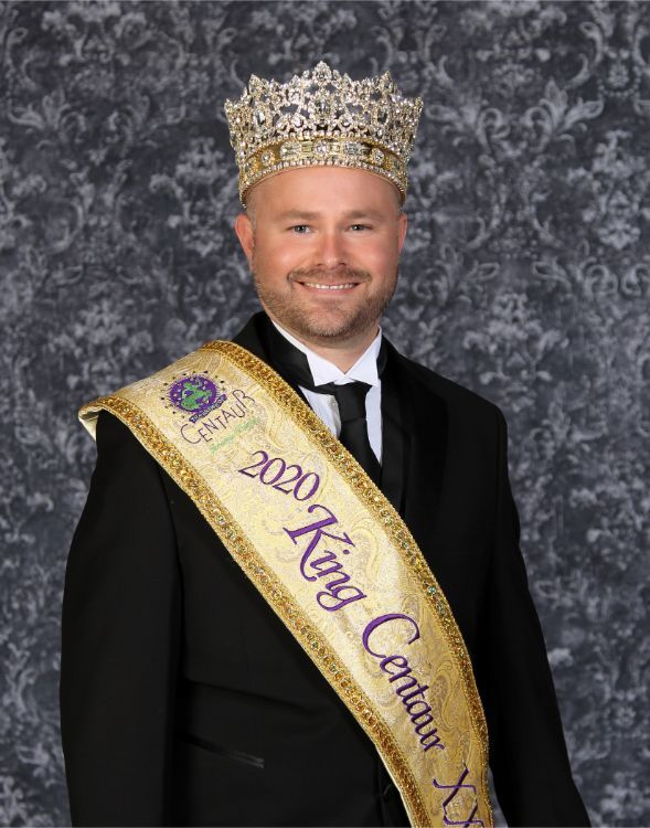 A man wearing a crown and a sash that says king centurion