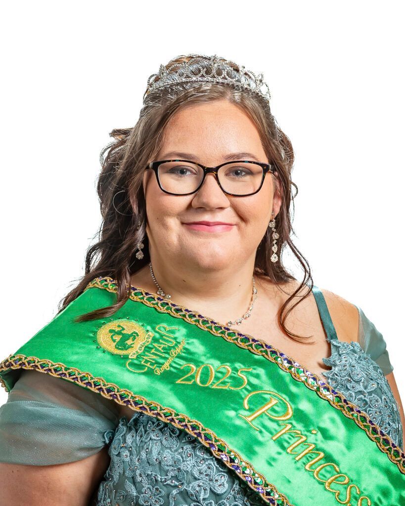 A woman is wearing a green sash and a tiara.