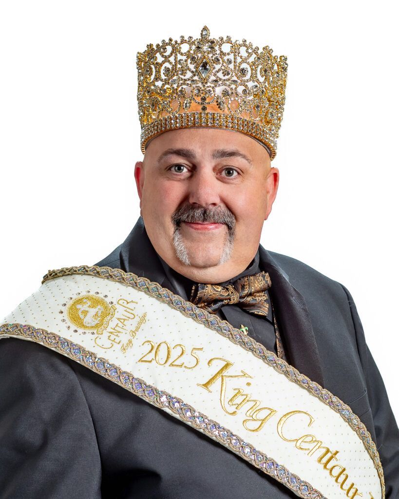 A man wearing a crown and a sash that says king centurion