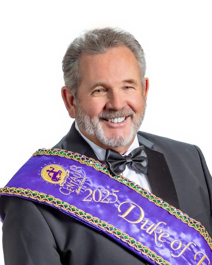 A man in a suit and bow tie is wearing a sash that says duke of florida.