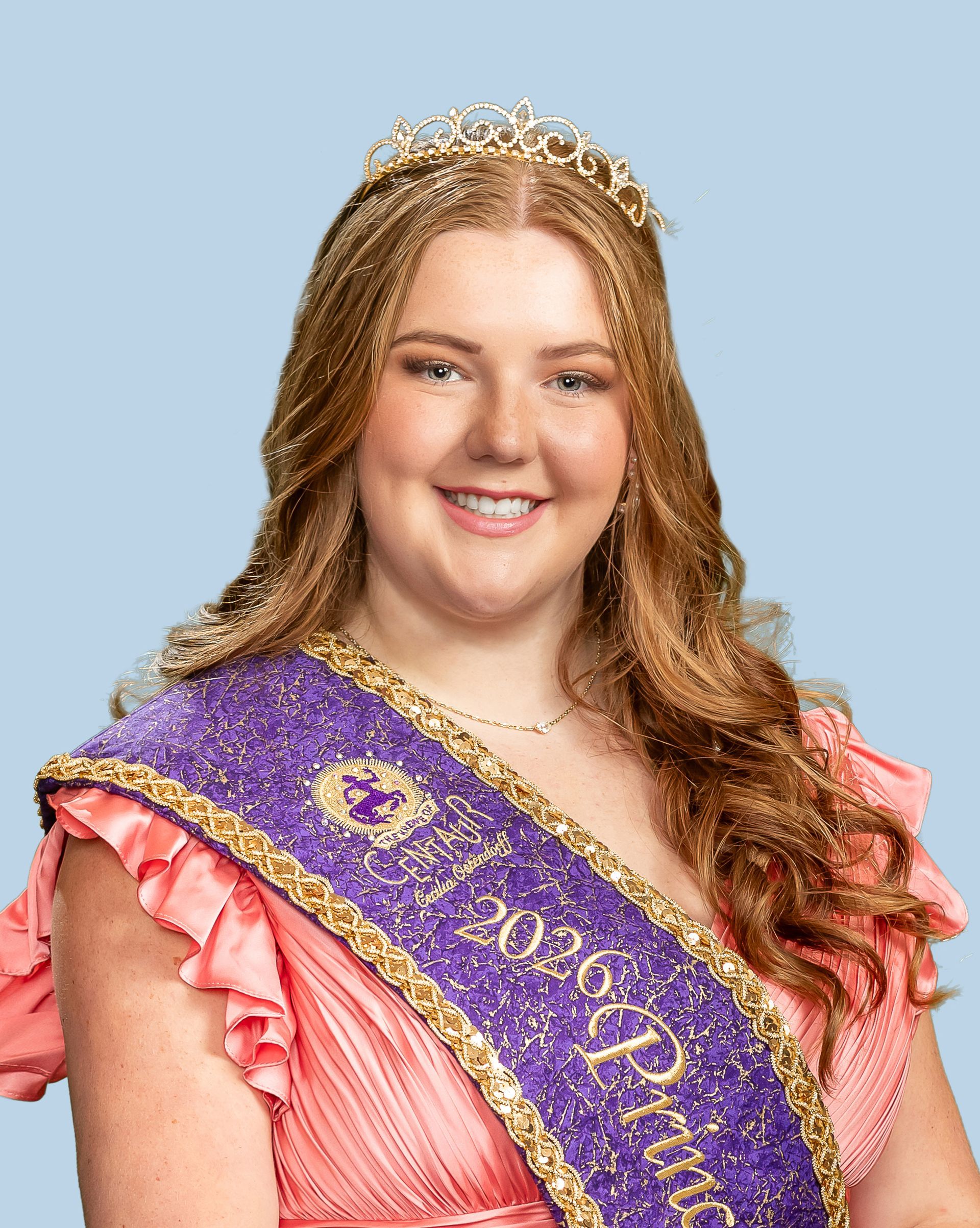 A woman wearing a purple sash and a tiara who is a princess. 