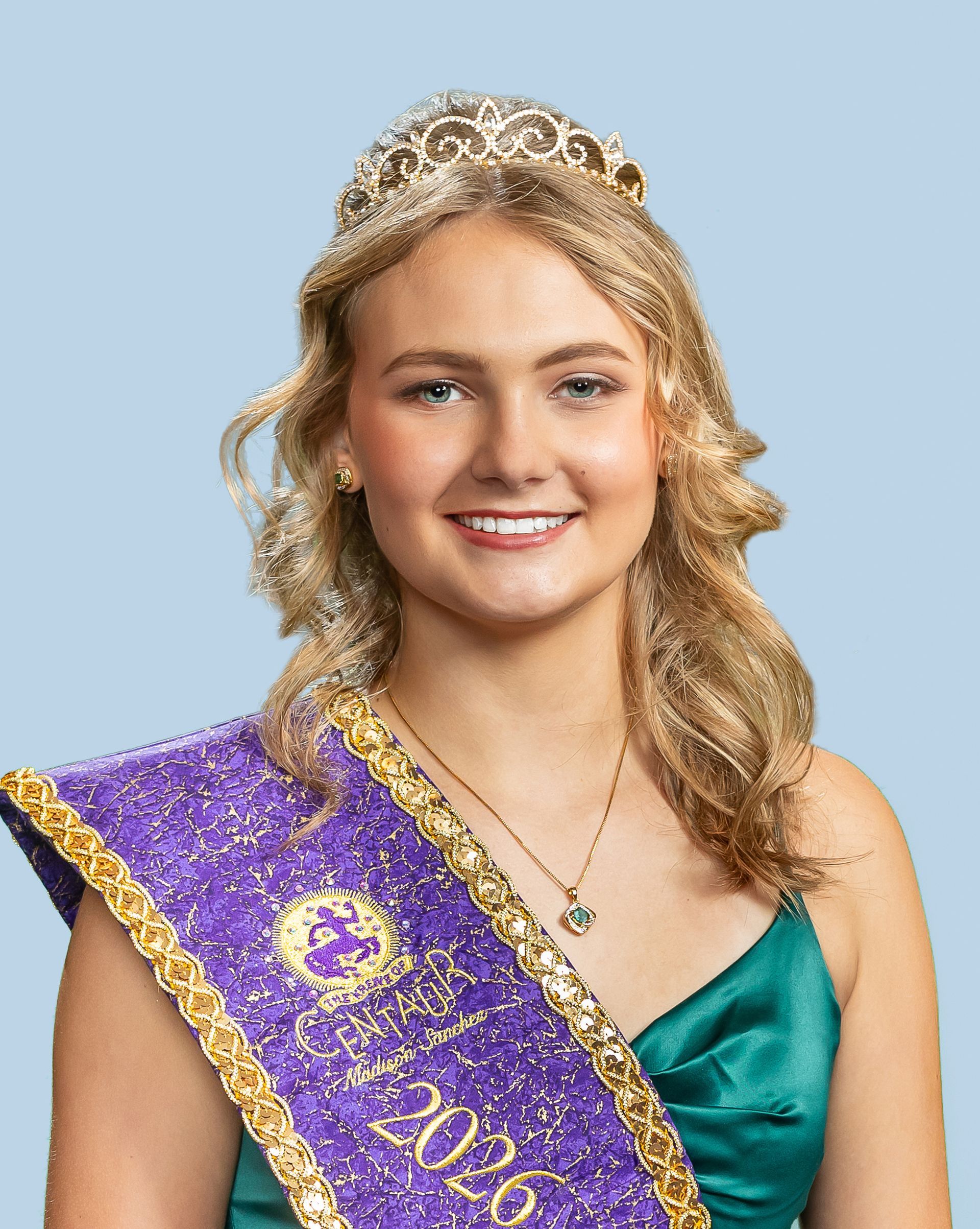 A woman wearing a purple sash and a tiara who is a princess. 