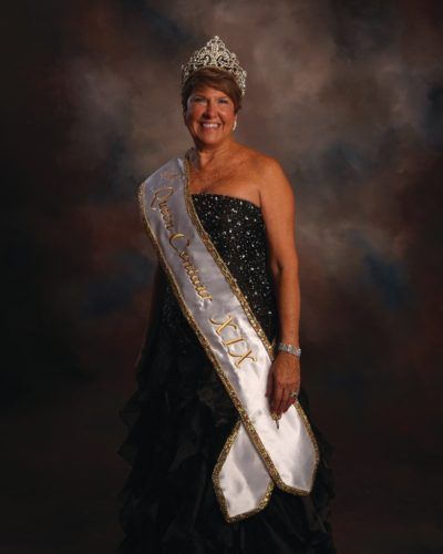 A woman wearing a sash that says rt on it
