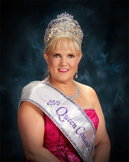 A woman wearing a crown and a sash that says 2016 queen carnival