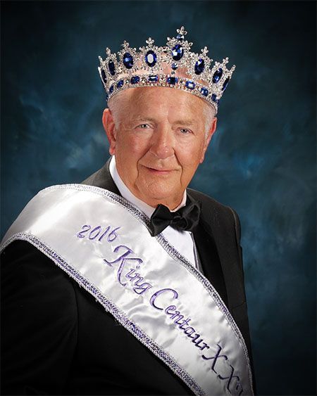 A man wearing a crown and a sash that says king centaur xxx