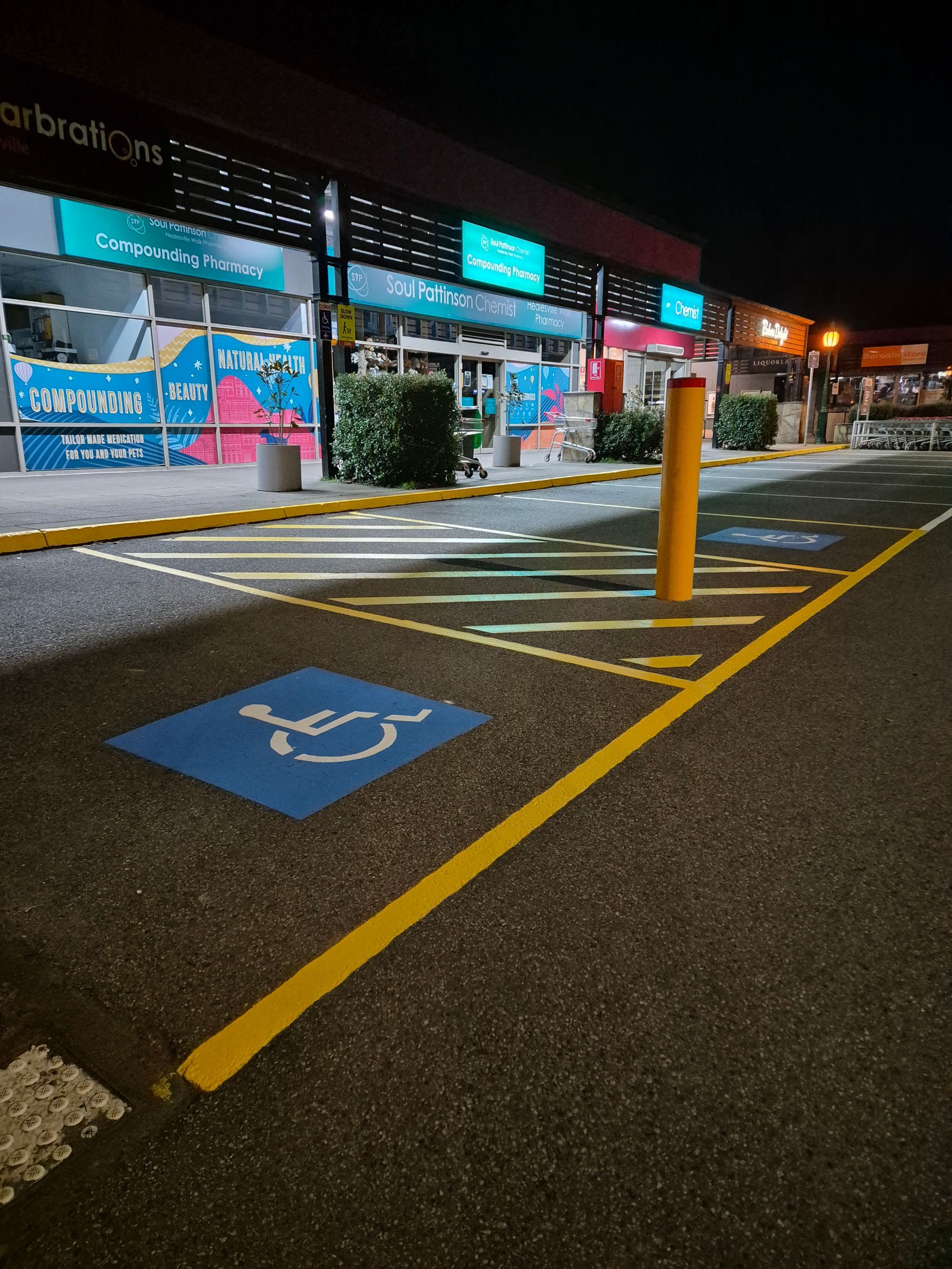 2 disabled bays and a shared zone line marking 