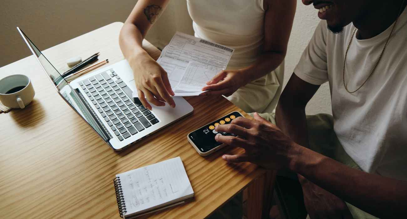 couple researching line of credit loans while adding up bills