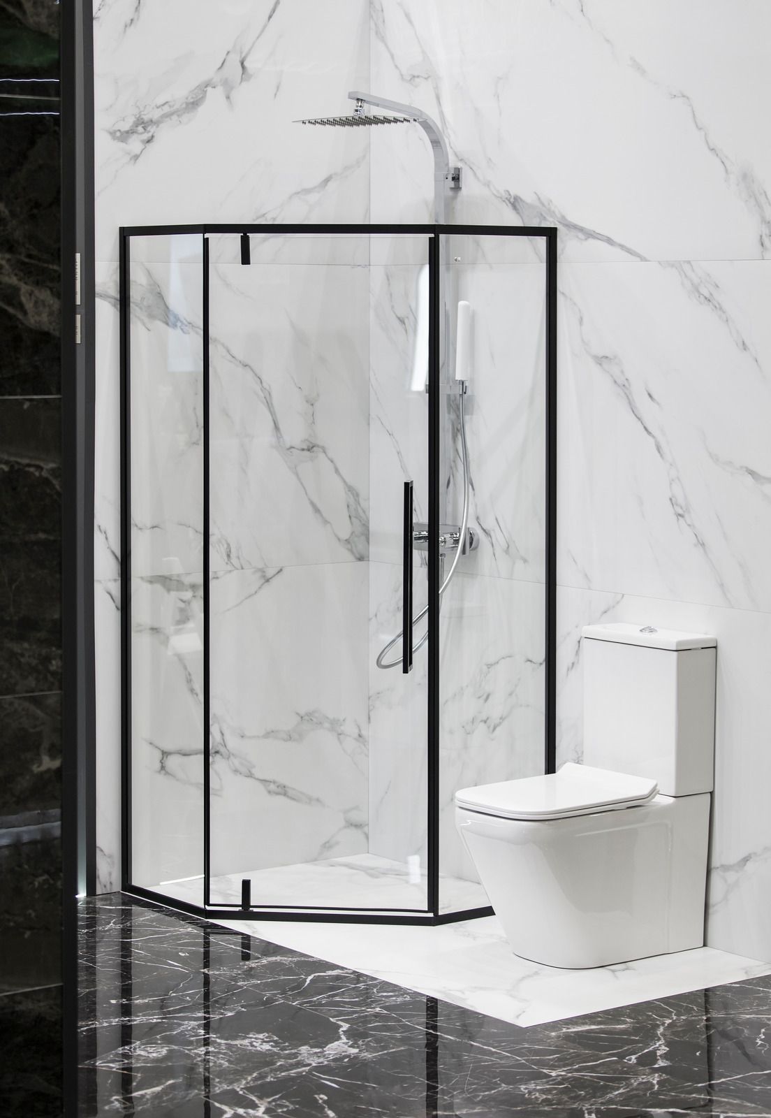 A bathroom with a shower stall and a toilet.