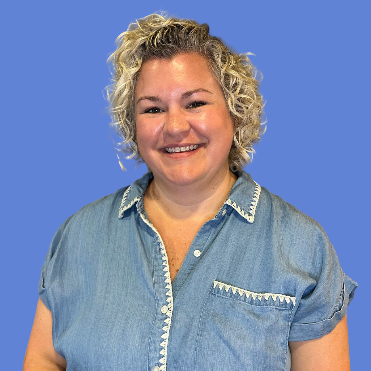 A woman wearing a black scrub top with the word gluck on it