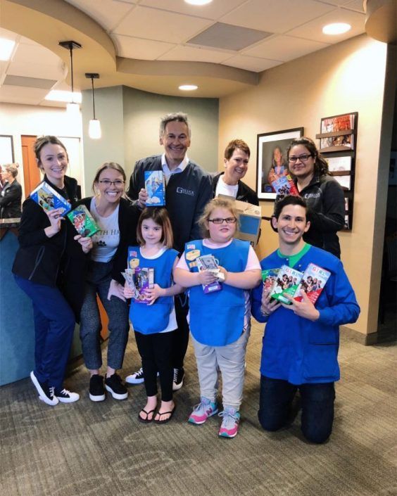 A group of people posing for a picture in a dental office