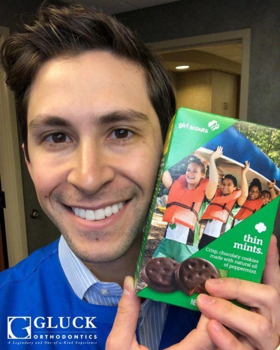 A man is holding a box of thin mints